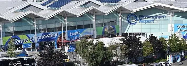 Birmingham Airport Taxi waiting outside terminal for pickup.
